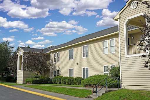 A beige building with a balcony on the right side.