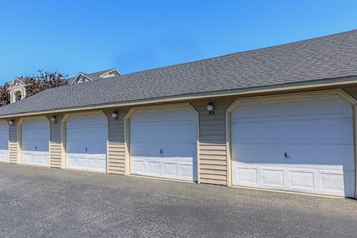 A row of white garage doors are closed.