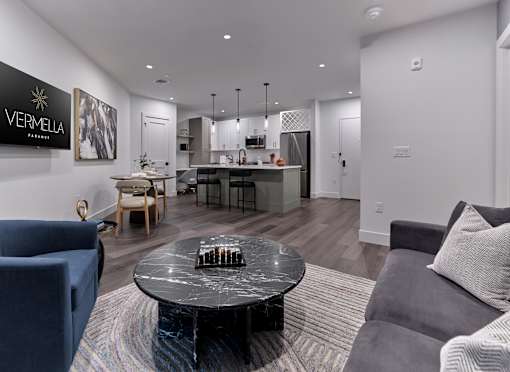 A living room with a black coffee table and a grey couch.