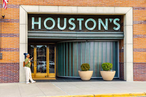 Houston's storefront with a woman standing outside.