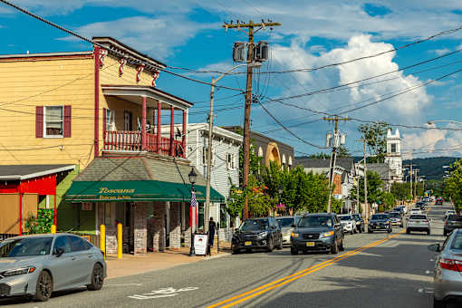 A street view with cars and buildings on a sunny day.