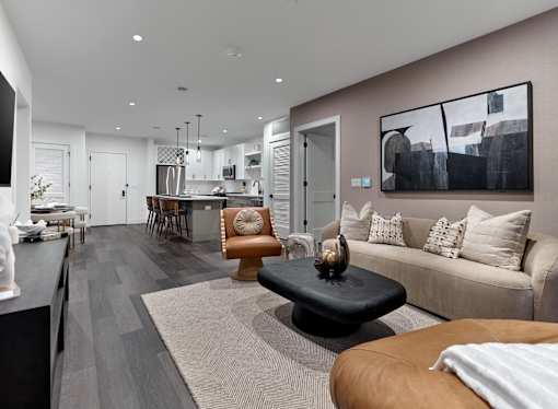 A modern living room with a black coffee table and a brown leather chair.