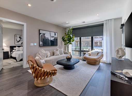A modern living room with a large window and a flat screen TV.