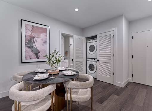 A modern dining room with a round table and chairs.