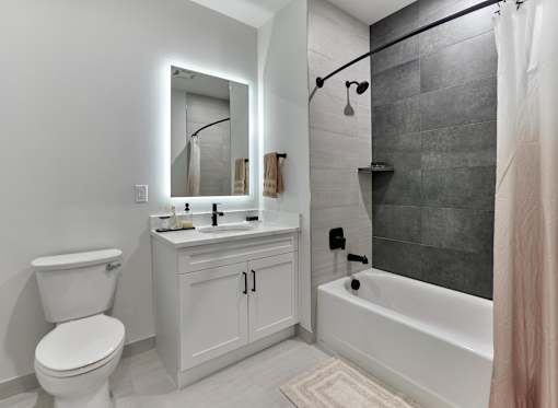 A white bathroom with a toilet, sink, and bathtub.