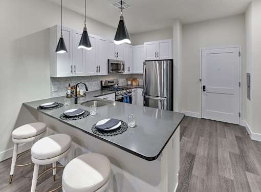 large kitchen, stainless steel appliances, custom cabinetry