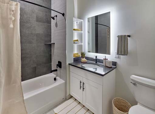 backlit vanity, marble tile shower