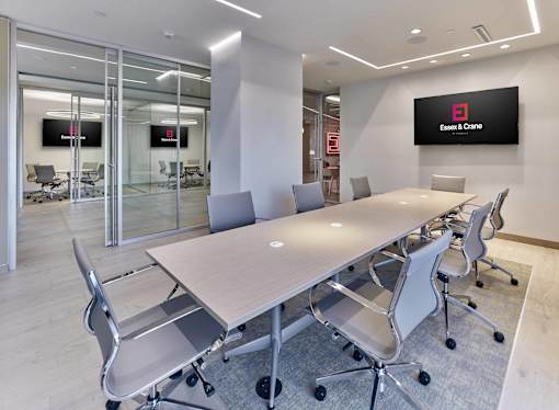 Clubroom with conference room, business center, and work-from-home amenities at Essex & Crane, Orange NJ
