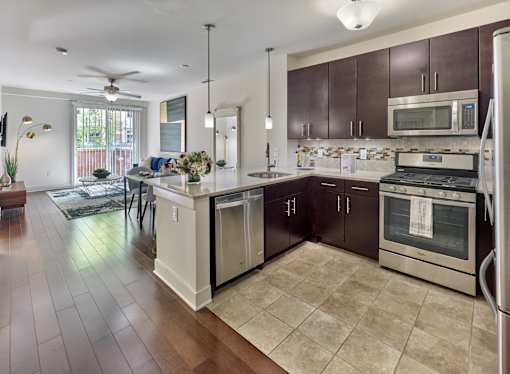 A kitchen with espresso cabinets and a white island.
