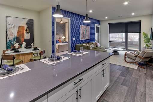 A modern kitchen with a dining table and chairs.