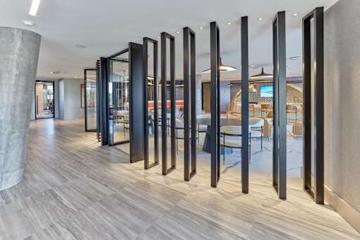 A long hallway with a row of black columns on the side.