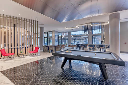 A pool table in a room with a shiny black floor.