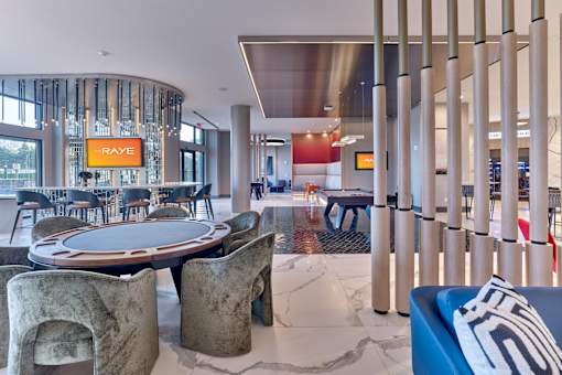 A modern dining area with a round table and chairs.