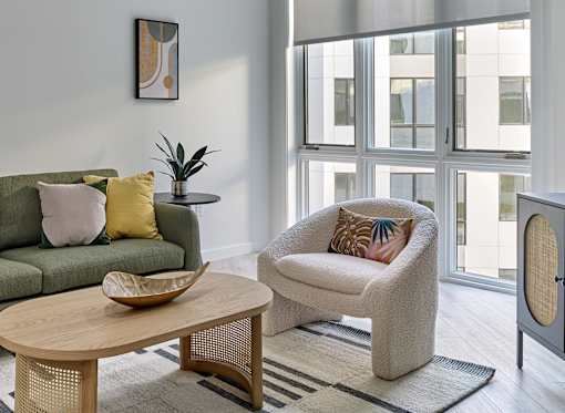Outdoor seating area with lush greenery and stylish furniture at Ora luxury apartments in Hackensack, NJ
