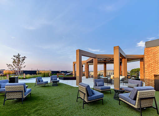 A patio with blue chairs and a white table.