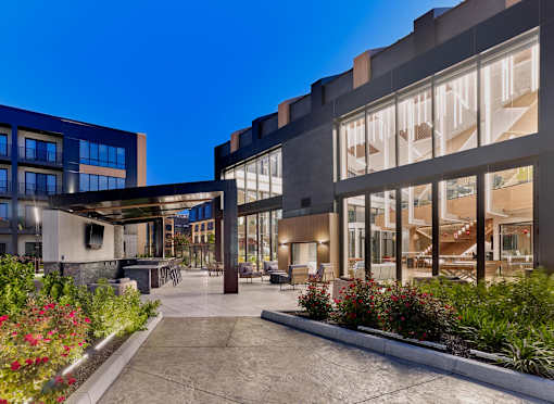 A modern building with a courtyard and plants.