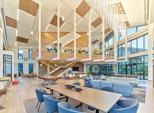 A modern open space with a long table and chairs.
