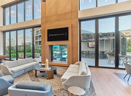 A living room with a large window and a sign that says