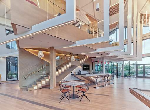 A modern interior with a staircase and a long table.