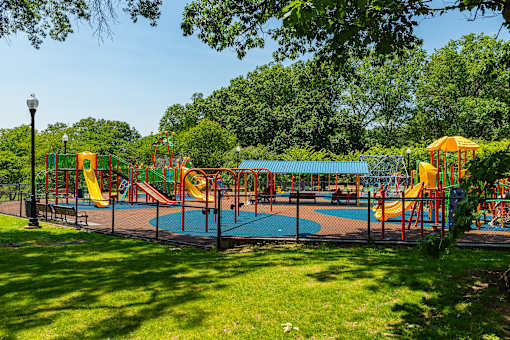 A playground with a blue slide and a yellow slide.