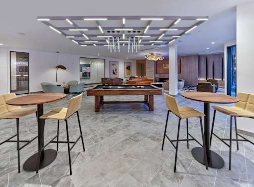 Club room with game tables, lounge and table seating, private resident club room