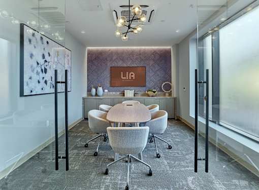 A conference room with a long table and chairs.