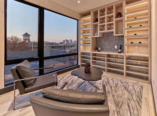 Resident amenities with bar area, clubroom, game tables, lounge seating, and private meeting room at Vermella Broad Street, Newark NJ