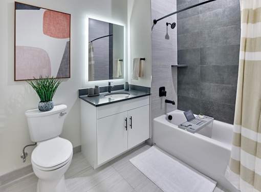 Luxury bathroom with tiled shower and backlit vanity at Vermella Broad Street, Newark NJ