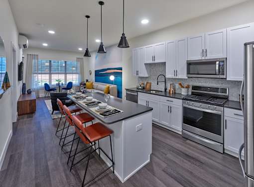 large one bedroom home, private balcony, open living space, large kitchen, stainless steel appliances