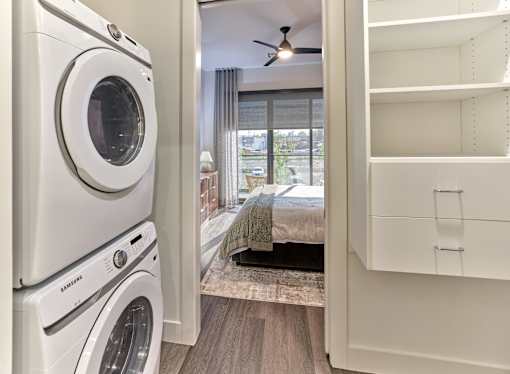 A white washing machine and dryer in a laundry room.