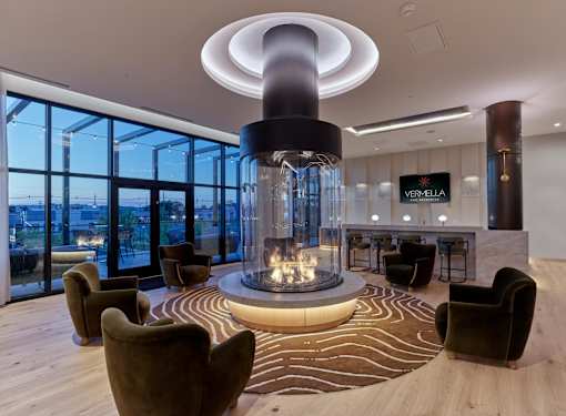A modern living room with a fireplace and a view of the city.