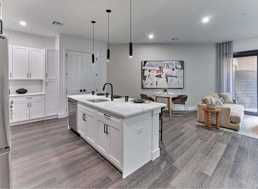 A modern kitchen with white cabinets and a large island.