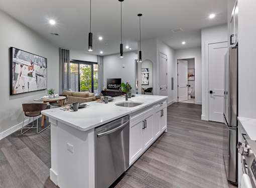 A modern kitchen with a large island and stainless steel appliances.