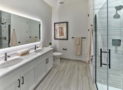 A bathroom with a towel hanging on the towel rack.