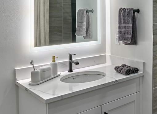 A white bathroom sink with a mirror above it.