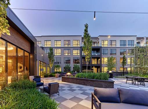 A modern outdoor seating area with a checkerboard patterned floor.