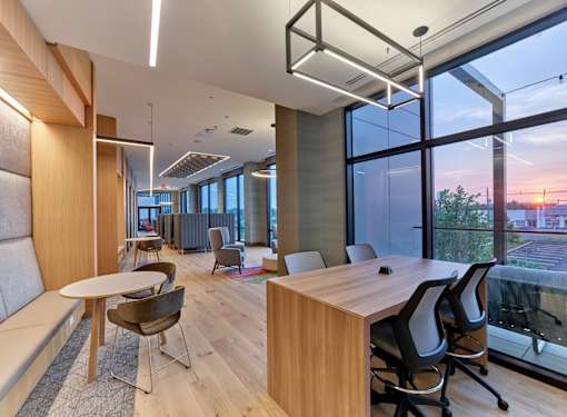 A modern office space with wooden furniture and large windows.