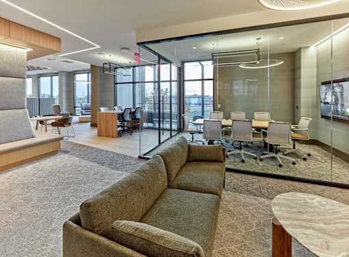 A modern office space with a large window and a glass wall.