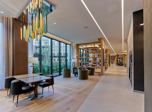 A modern dining area with a long table and chairs.