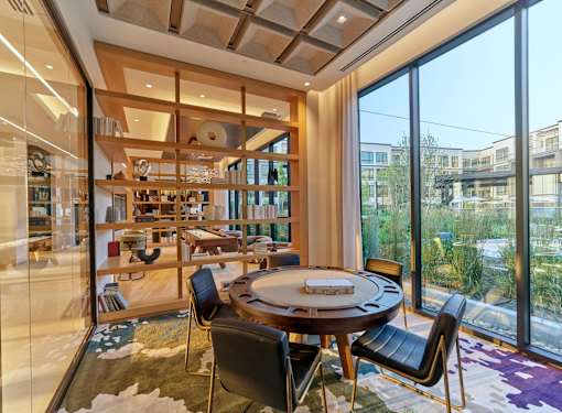 A modern dining room with a round table and chairs.