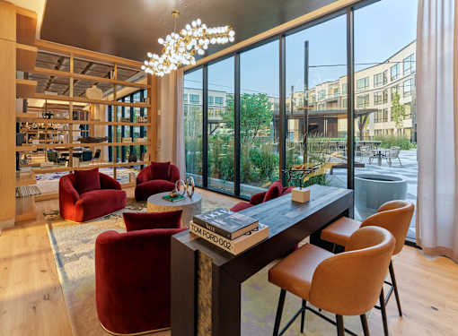 A modern living room with a large window overlooking a garden.