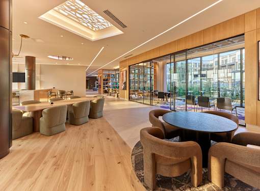 A modern lounge area with wooden floors and furniture.