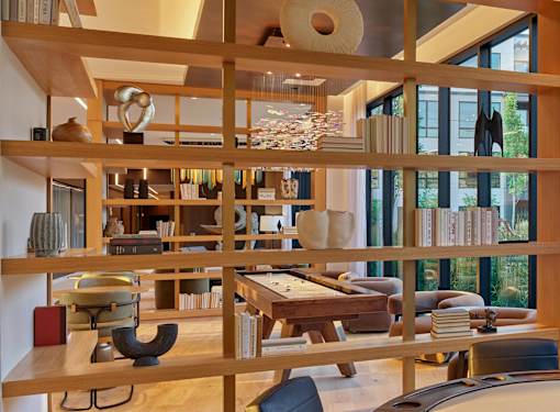 A room with a lot of shelves and a table.