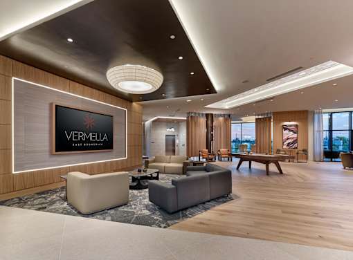 A living room with a Vermeila sign on the wall.