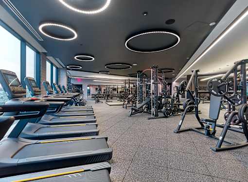 A gym with treadmills and other exercise equipment.