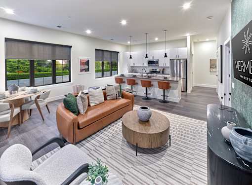 A living room with a couch, chairs, and a coffee table.