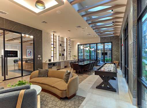 A modern living room with a pool table and a bar area.