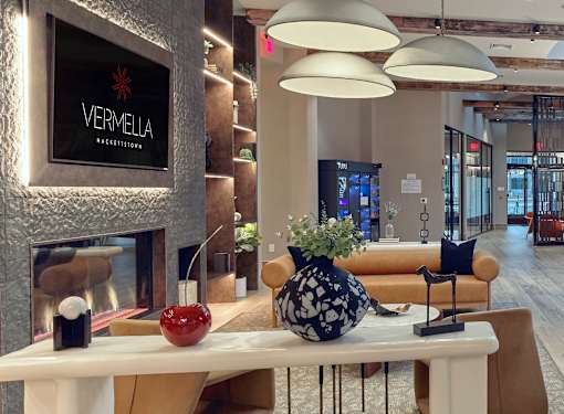 A modern lobby with a fireplace and a sign that says