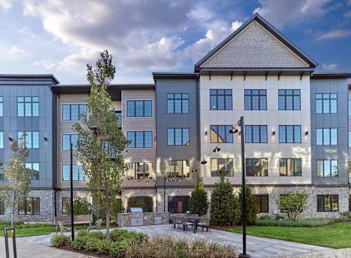 A modern building with a mix of stone and glass windows.