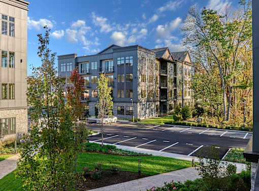 A large building with a parking lot in front of it.
